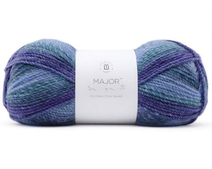 A skein of yarn with a white paper label reading 'MAJOR' and '100% Acrylic' on a plain white background.